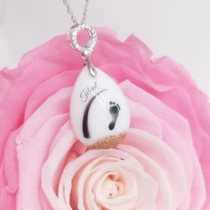 Collier Ma goutte d'amour lactée en résine de lait maternel blanc nacré sur chaîne, fond blanc