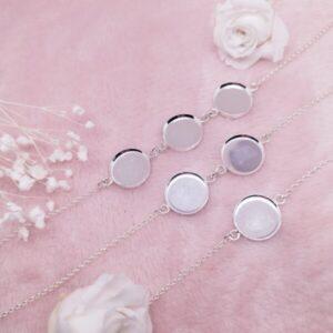 Médaillon 1 petit médaillon en résine de lait maternel sur chaîne dorée, fond blanc