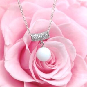 Collier Serrena en résine de lait maternel blanc nacré sur chaîne, fond blanc
